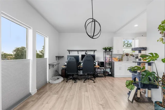 a kitchen with kitchen island stainless steel appliances a sink a counter top space cabinets and a window