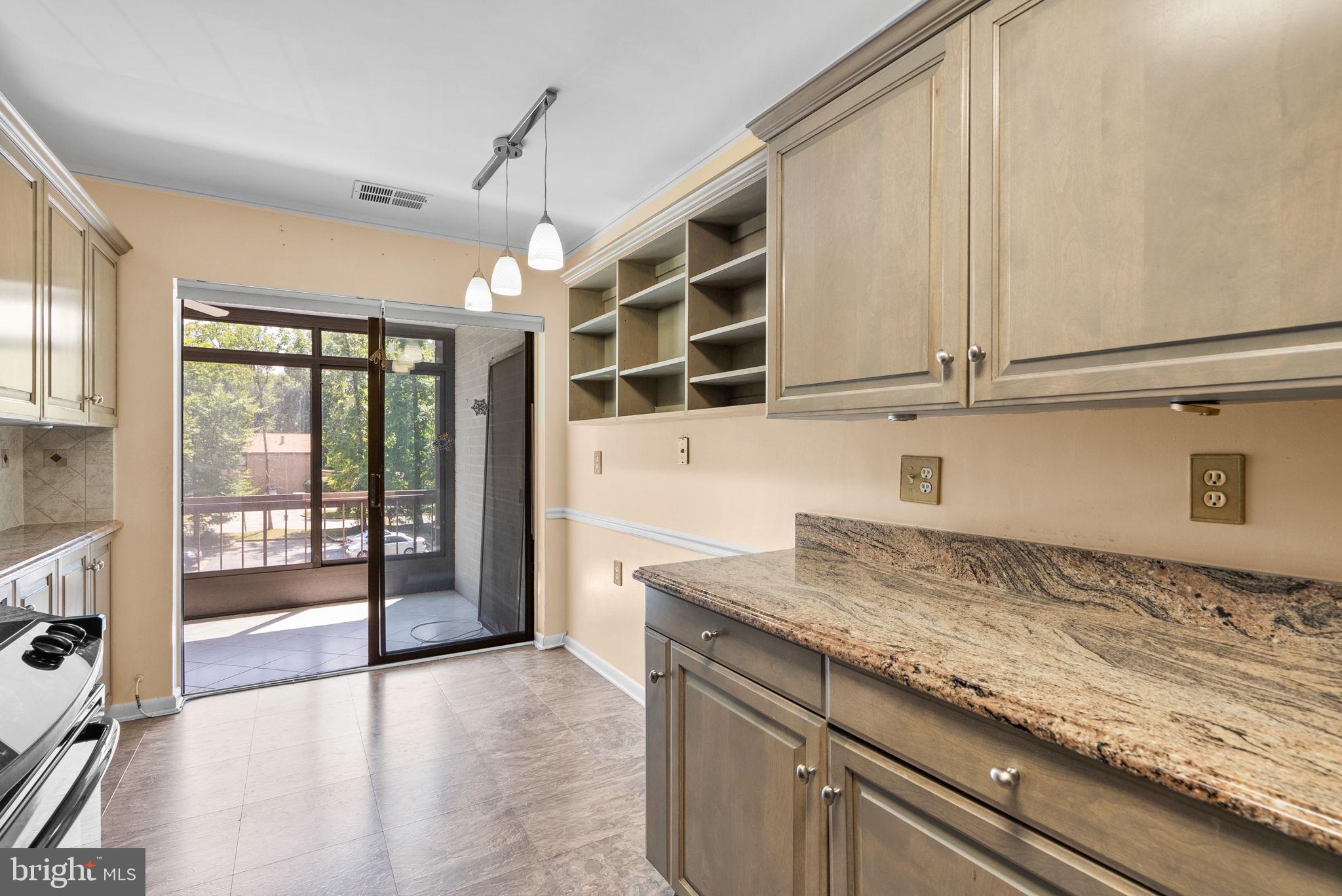 6300 Red Cedar Place, Unit 310 Baltimore, MD 21209 - Photo 11 of 28 a kitchen with granite countertop a sink and a window
