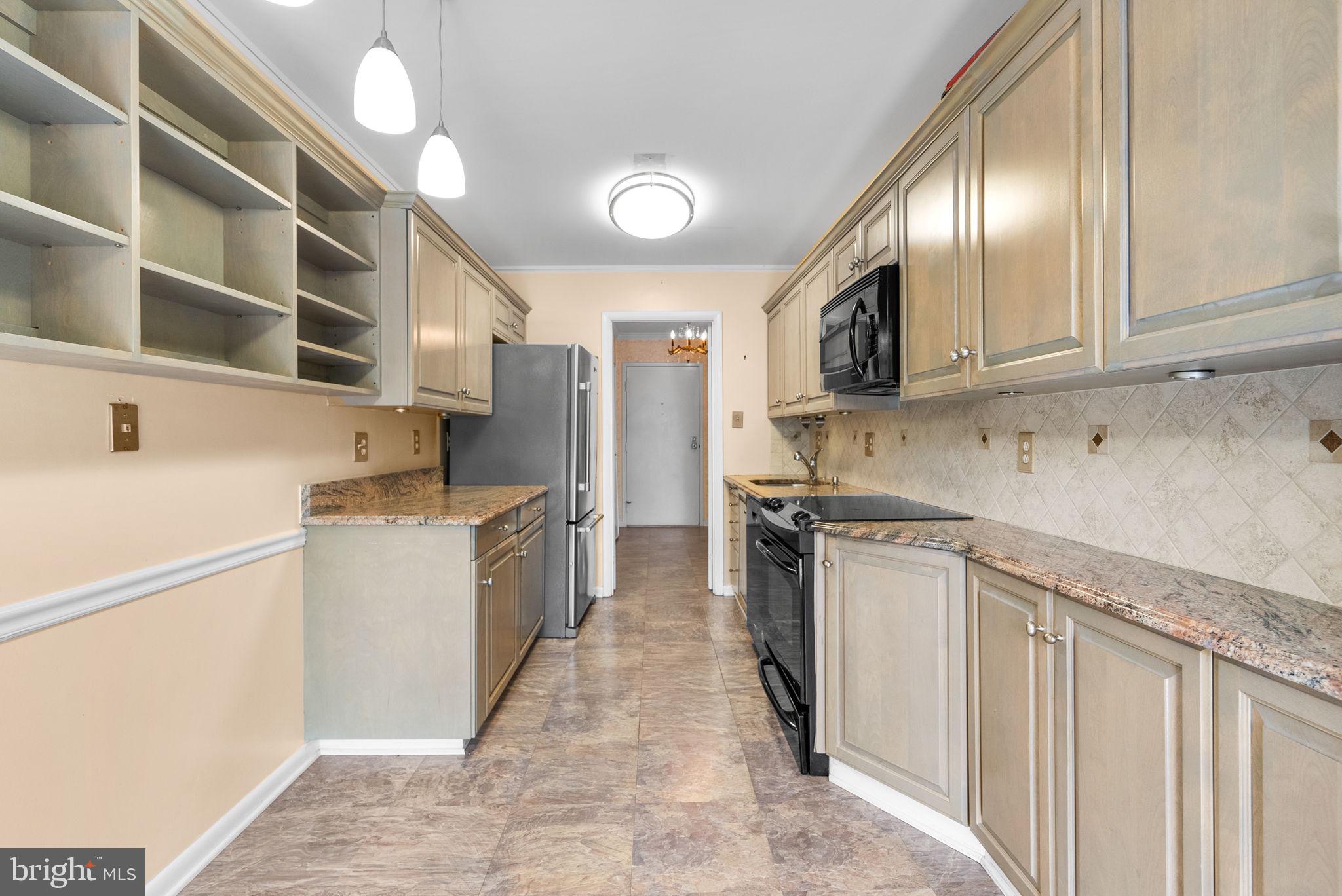 6300 Red Cedar Place, Unit 310 Baltimore, MD 21209 - Photo 13 of 28 a kitchen with stainless steel appliances granite countertop a sink and cabinets