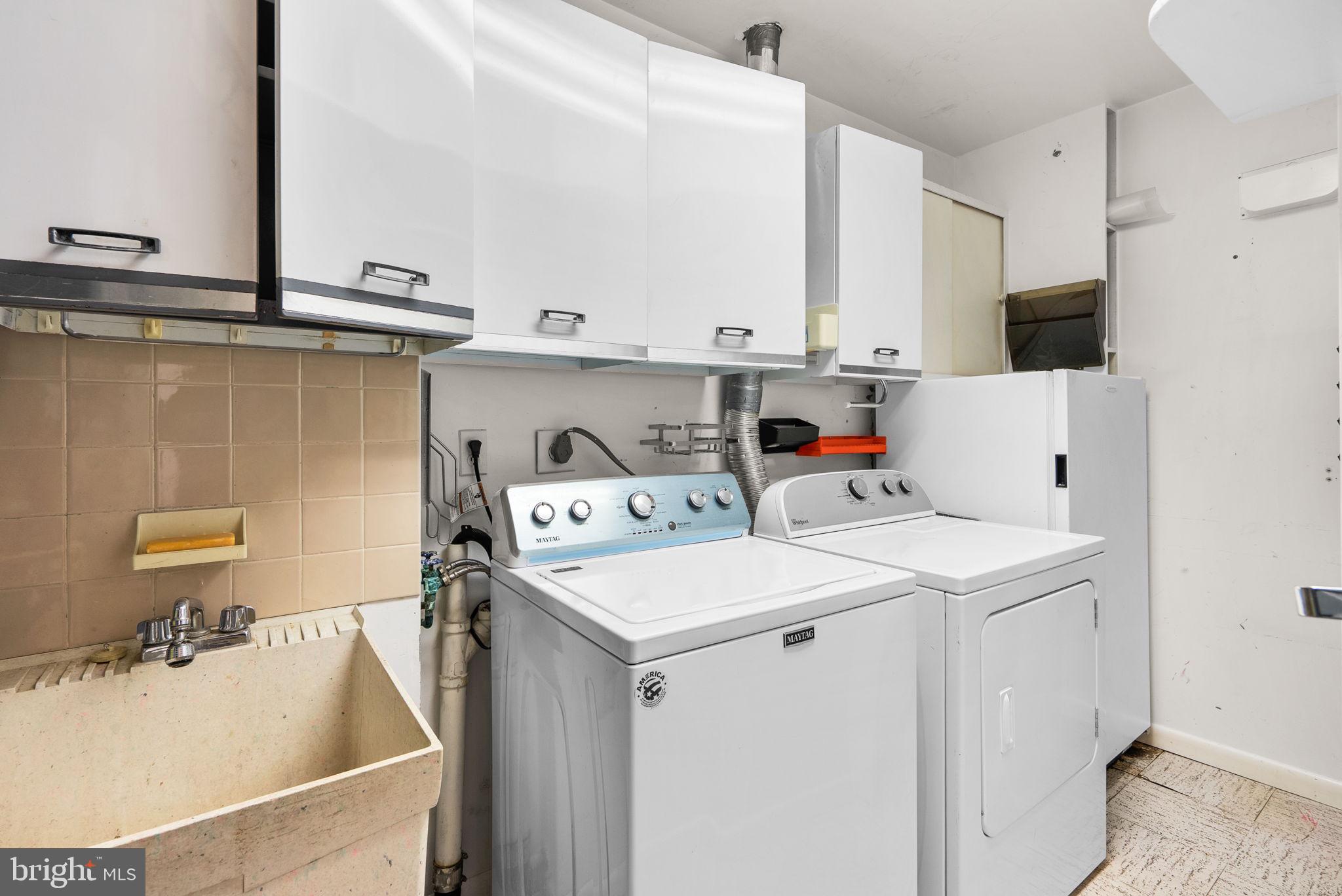 6300 Red Cedar Place, Unit 310 Baltimore, MD 21209 - Photo 25 of 28 a utility room with dryer and washer