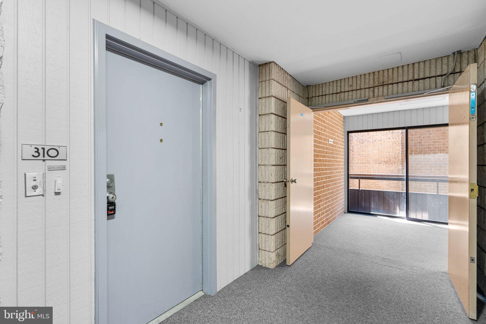 6300 Red Cedar Place, Unit 310 Baltimore, MD 21209 - Photo 3 of 28 a view of an empty room with a balcony