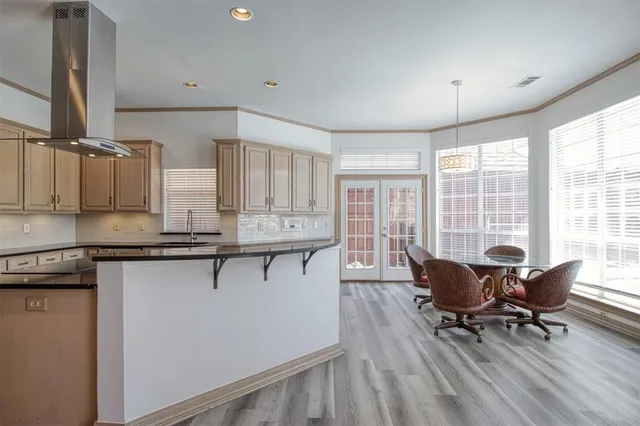 a kitchen with stainless steel appliances granite countertop sink stove and wooden cabinets