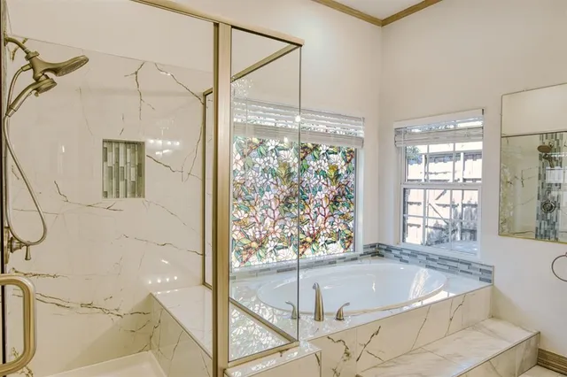 a bathroom with a tub and a large window