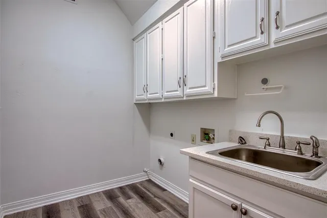 a view of a kitchen with sink and cabinets