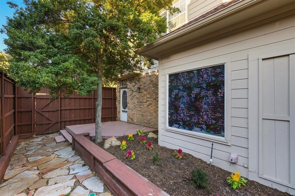 4564 Hitching Post Lane Plano, TX 75024 - Photo 32 of 40 a wooden bench sitting in front of a building