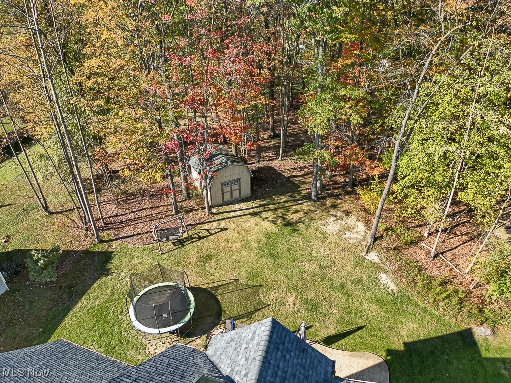 3982 Baird Road Stow, OH 44224 - Photo 42 of 50 View of green lawn with a fire pit and a storage shed