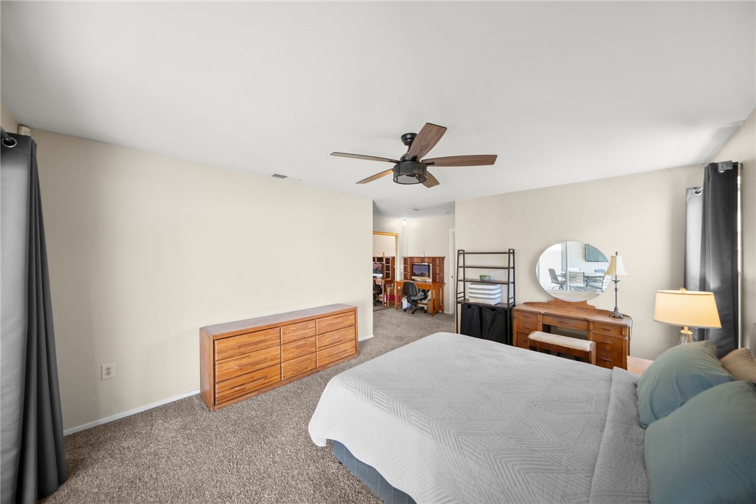 27879 Foxfire Street Menifee, CA 92586 - Photo 28 of 36 a bed room with a bed and a ceiling fan