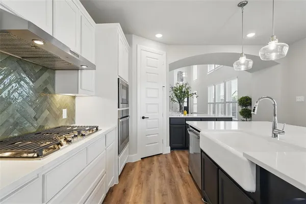 a kitchen with a sink stove and refrigerator