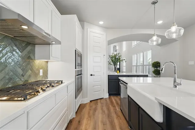 a kitchen with a sink stove and refrigerator