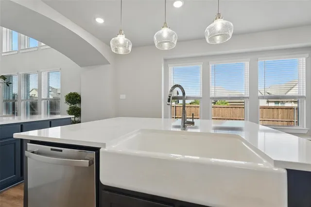 a kitchen with a table and a large window