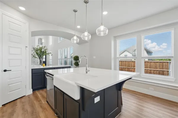 a large kitchen with a table and chairs
