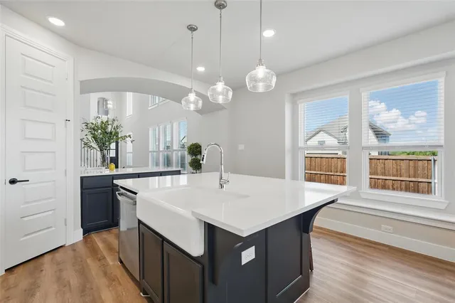 a large kitchen with a table and chairs