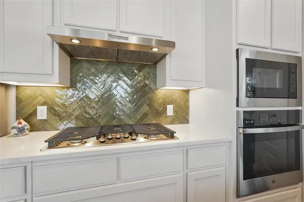 a kitchen with a stove and a microwave