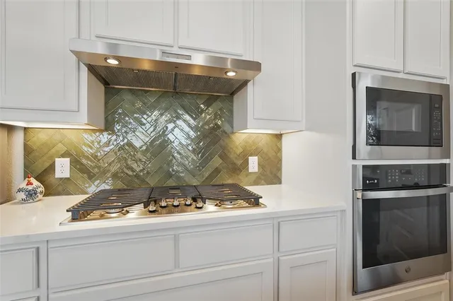 a kitchen with a stove and a microwave