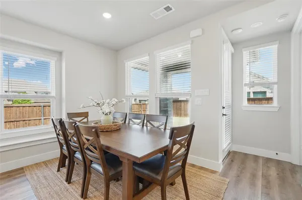 a view of a dining room with furniture and wooden floor