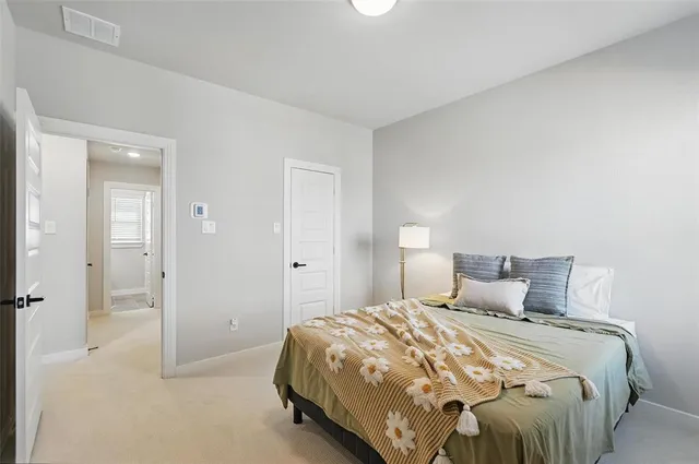 a bedroom with a bed and a night stand