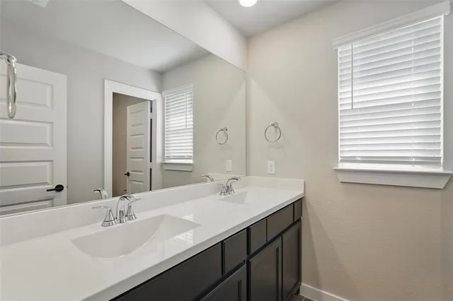 a bathroom with a sink double vanity and a mirror