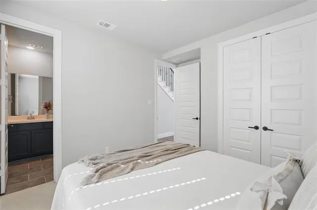 a bedroom with a bed and a mirror