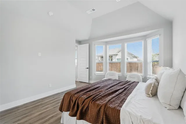 a bedroom with a bed and glass door