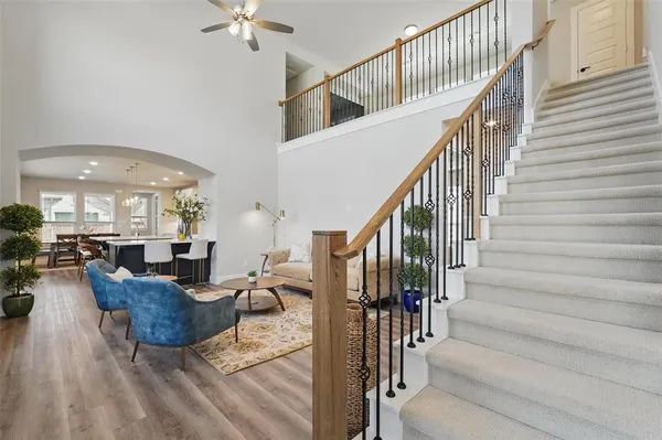 a view of a livingroom with furniture and staircase