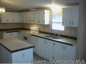8267 Godwin-Falcon Road Godwin, NC 28344 - Photo 6 of 10 a kitchen with a sink white cabinets and white appliances