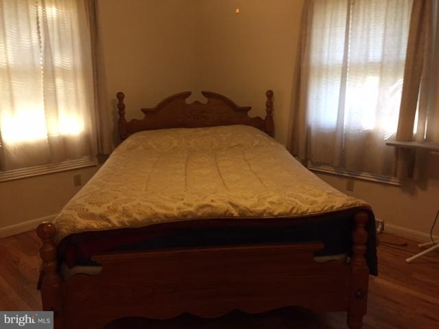 8262 WB&A Road Severn, MD 21144 - Photo 11 of 22 a bed sitting in a bedroom next to a window