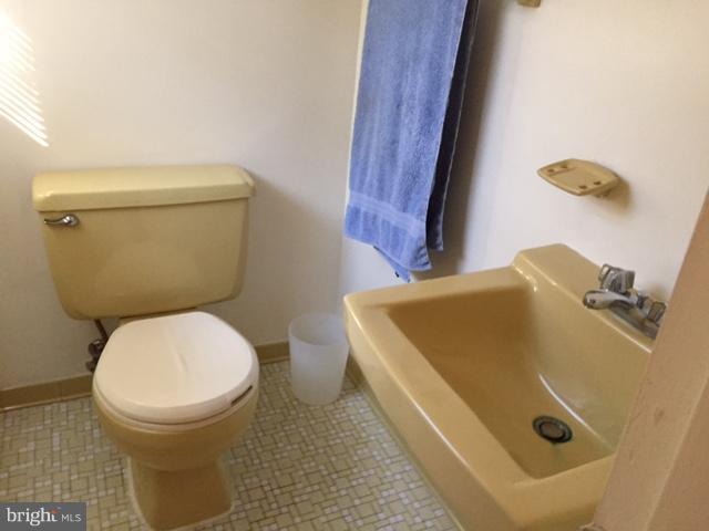 8262 WB&A Road Severn, MD 21144 - Photo 12 of 22 a bathroom with a toilet and a sink
