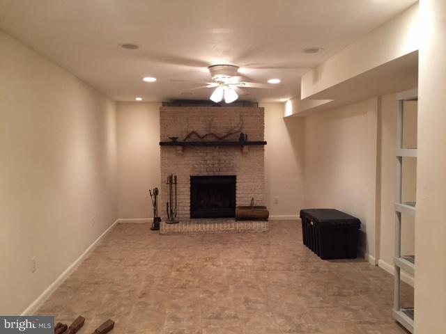 8262 WB&A Road Severn, MD 21144 - Photo 15 of 22 a view of a livingroom with a ceiling fan and fireplace