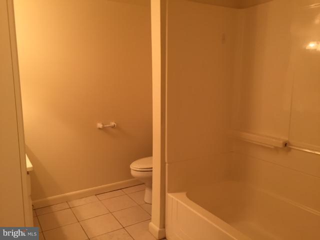 8262 WB&A Road Severn, MD 21144 - Photo 16 of 22 a bathroom with a granite countertop toilet and a sink