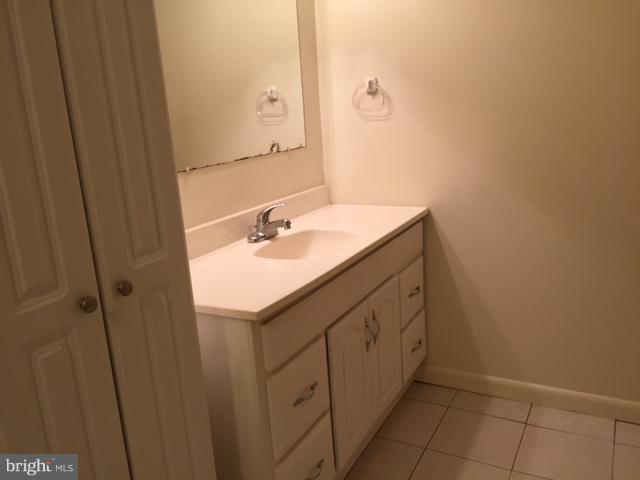 8262 WB&A Road Severn, MD 21144 - Photo 17 of 22 a bathroom with a sink and a mirror