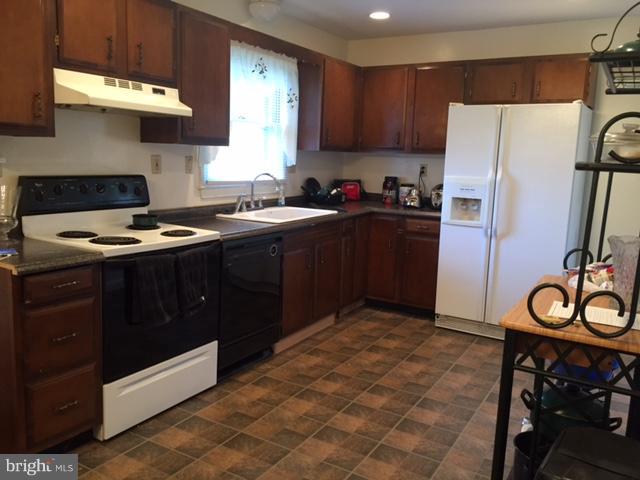 8262 WB&A Road Severn, MD 21144 - Photo 3 of 22 a kitchen with a stove a refrigerator and a sink