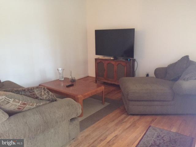 8262 WB&A Road Severn, MD 21144 - Photo 7 of 22 a living room with furniture and a flat screen tv