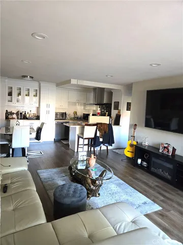 a living room with lots of furniture and kitchen view