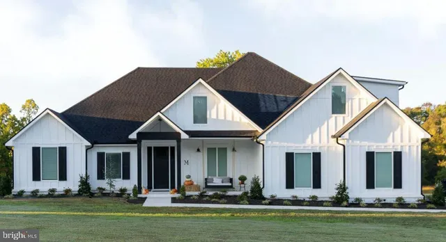 a view of a house with pool lawn chairs and a potted plant