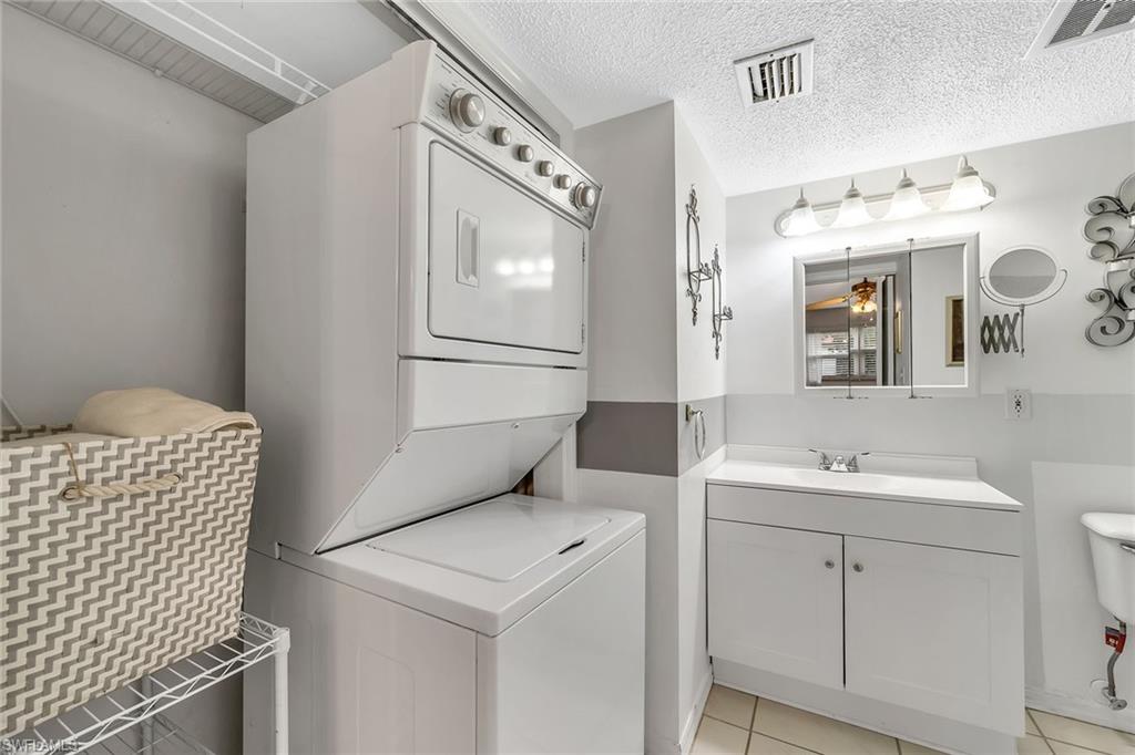 200 Valley Stream Drive, Unit 3B Naples, FL 34113 - Photo 19 of 45 a bathroom with a sink and a mirror