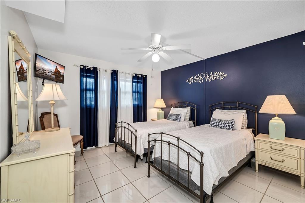 200 Valley Stream Drive, Unit 3B Naples, FL 34113 - Photo 21 of 45 a bedroom with bed and a large mirror