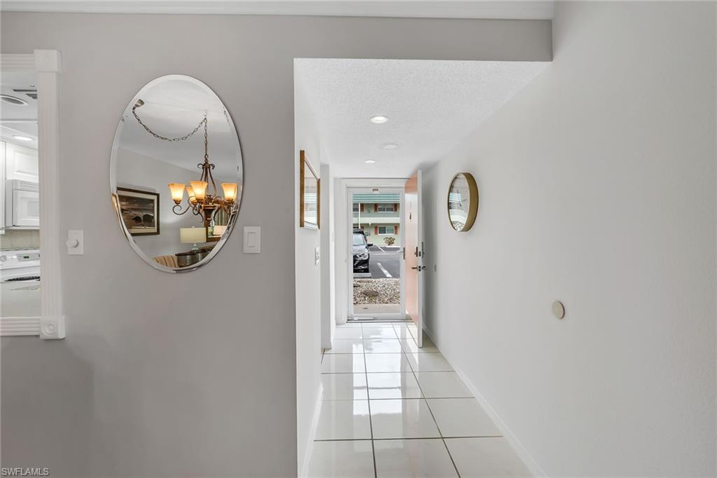 200 Valley Stream Drive, Unit 3B Naples, FL 34113 - Photo 23 of 45 a bathroom with a mirror and a shower