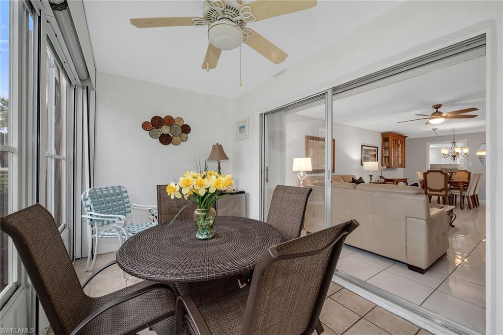 200 Valley Stream Drive, Unit 3B Naples, FL 34113 - Photo 26 of 45 a view of a dining room with furniture and chandelier