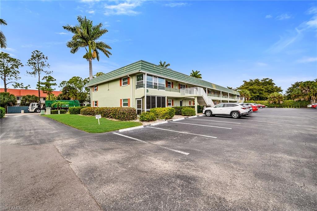 200 Valley Stream Drive, Unit 3B Naples, FL 34113 - Photo 30 of 45 a car parked in front of a house with a yard