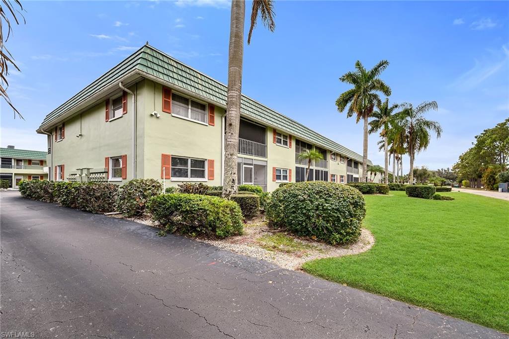 200 Valley Stream Drive, Unit 3B Naples, FL 34113 - Photo 31 of 45 a front view of a house with a garden