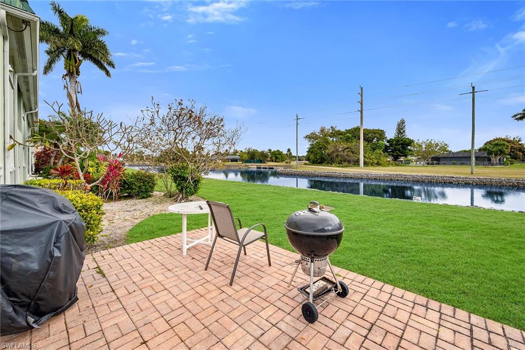 200 Valley Stream Drive, Unit 3B Naples, FL 34113 - Photo 34 of 45 a view of a chairs and table in patio with a lake