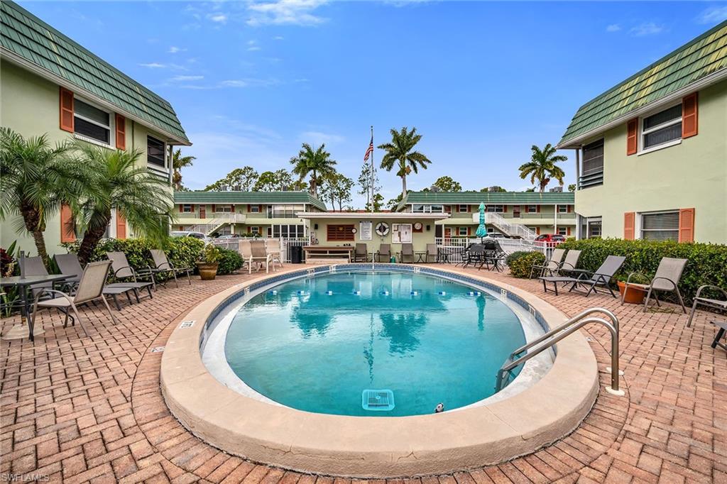 200 Valley Stream Drive, Unit 3B Naples, FL 34113 - Photo 36 of 45 a view of swimming pool with outdoor seating