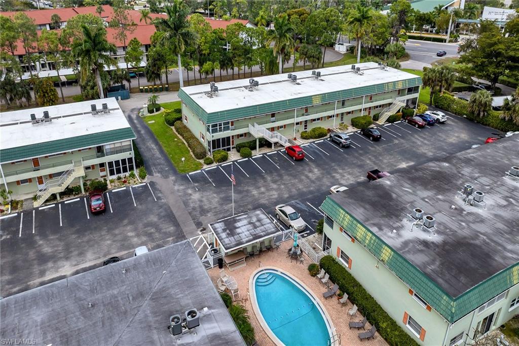 200 Valley Stream Drive, Unit 3B Naples, FL 34113 - Photo 43 of 45 a view of outdoor space with seating area and car parked
