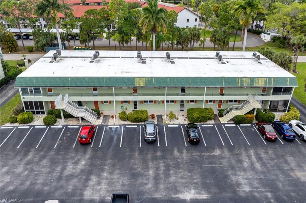 200 Valley Stream Drive, Unit 3B Naples, FL 34113 - Photo 44 of 45 an outdoor space with patio and furniture