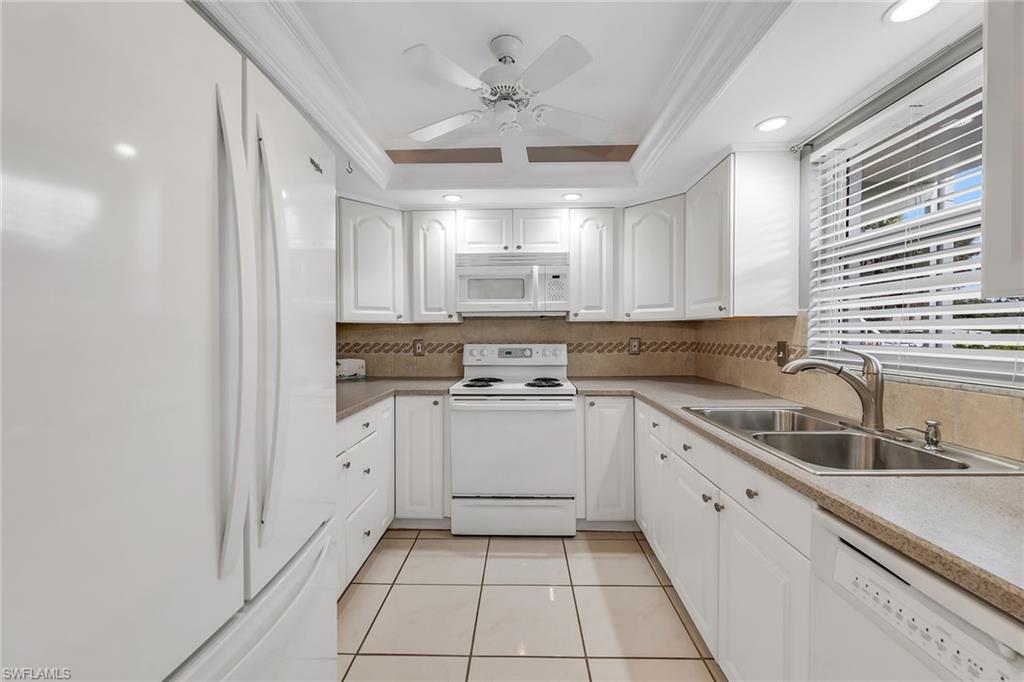 200 Valley Stream Drive, Unit 3B Naples, FL 34113 - Photo 8 of 45 a kitchen with a sink cabinets and window