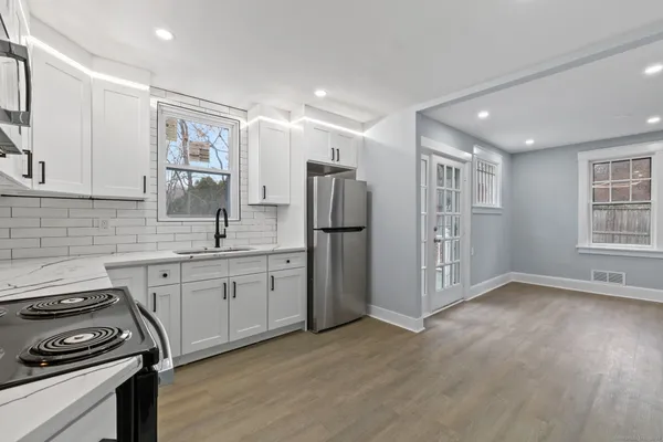 a kitchen with refrigerator and window