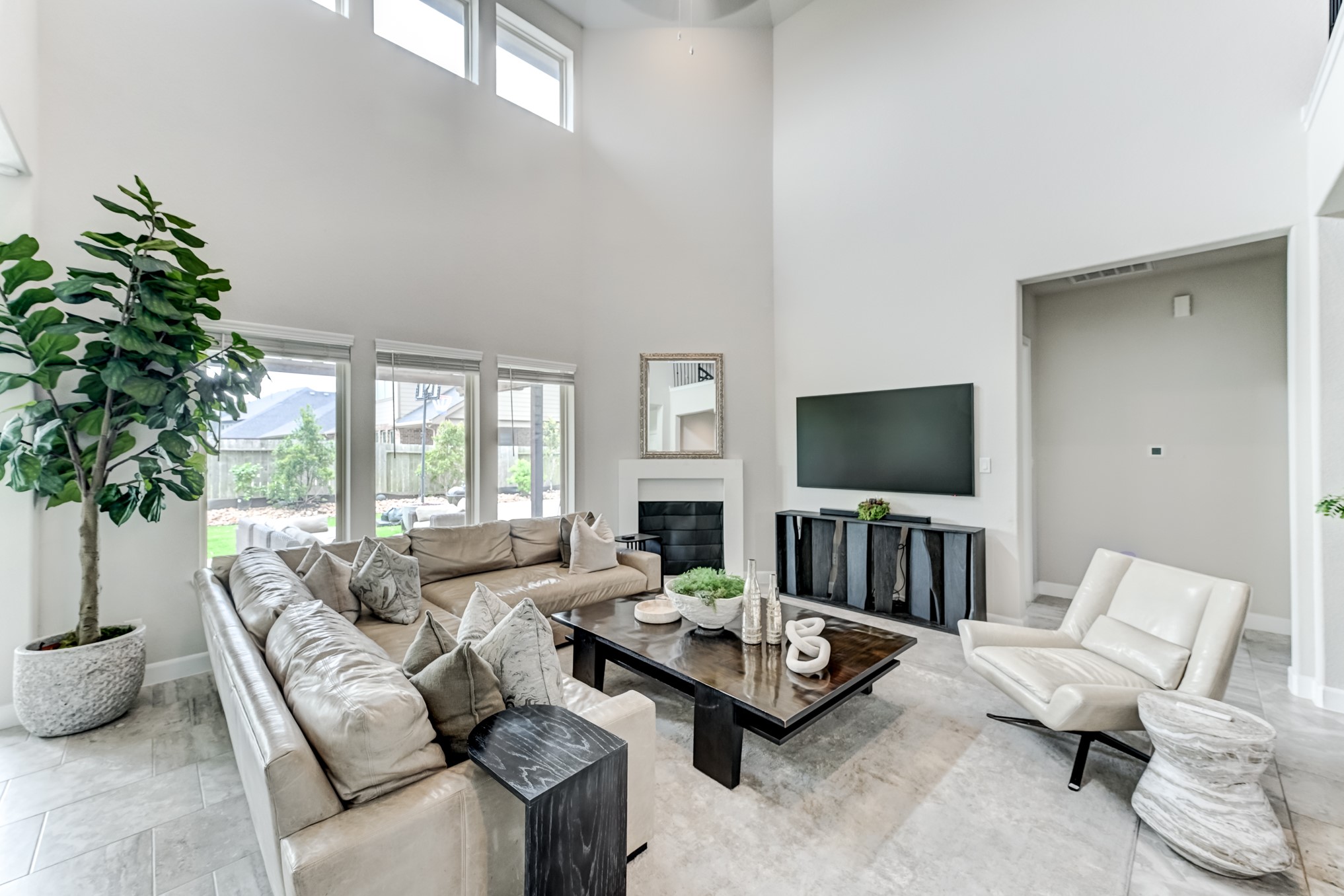 5806 Metaphor Way Rosenberg, TX 77469 - Photo 11 of 50 a living room with furniture a flat screen tv and a large window
