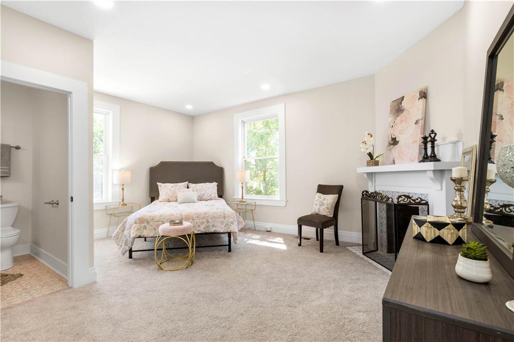 1015 Greentree Road Pittsburgh, PA 15220 - Photo 11 of 25 Spacious Master Suite with Decorative Fireplace, Neutral Carpet and Recessed Lighting