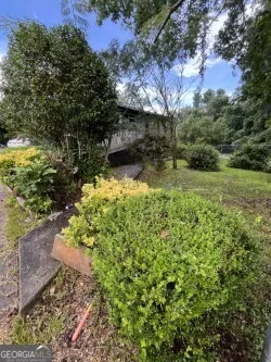 a backyard of a house with a yard and outdoor seating