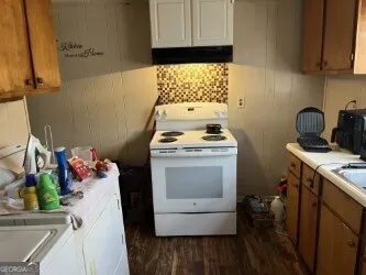 a room with a stove a sink and dishwasher